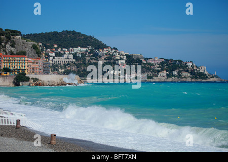Raue Meer auf den Strand und den Mont Boron mit dem Kap von Nizza im Hintergrund Stockfoto