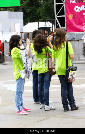 Teenager tragen helle grüne T-shirts fotografieren während im Urlaub in London Stockfoto