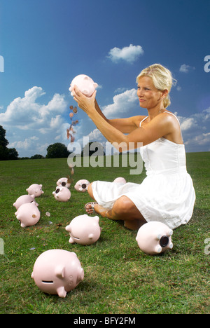 Frau schütteln Sparschwein Stockfoto