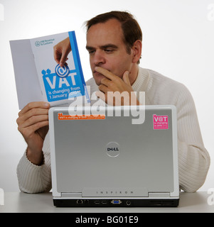 MwSt-Änderungen für 2010 Mann studieren HM Revenue & Zoll-Informations-Broschüre Stockfoto