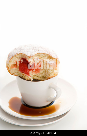 Leere Tasse Kaffee und gezuckerten Krapfen Wit Biss, isoliert auf weißem Hintergrund Stockfoto