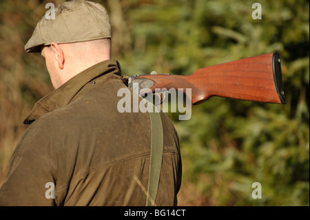 grobe Shooter Gewehr über der Schulter tragen Stockfoto