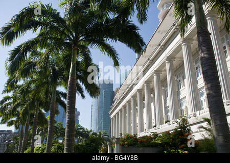 Die Fassade des Fullerton Hotel in Singapur mit den Gebäuden des Finanzviertels im Hintergrund. Stockfoto