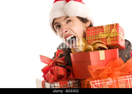 Gelangweilt Weihnachten junge hält Geschenke Gähnen isoliert auf weißem Hintergrund Stockfoto