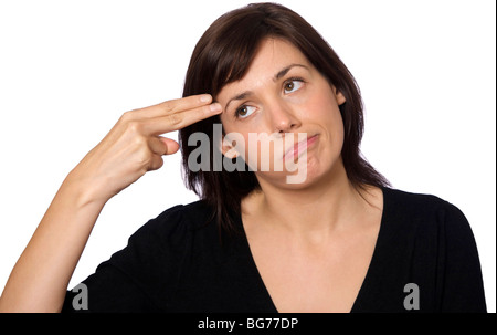 Frau schießen sich in den Kopf mit den Fingern Stockfoto