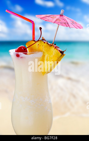 Pina Colada trinken im Cocktailglas mit tropischen Strand im Hintergrund Stockfoto