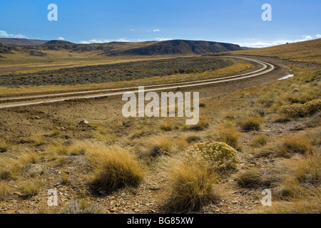 Schotterstraße führt durch Wüste Landschaft, Wyoming, USA Stockfoto