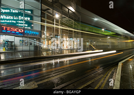 Nottingham-Straßenbahnen in und um die Stadt an der Spitze-Markt halten mit Geschäften und Tesco express im Hintergrund Stockfoto