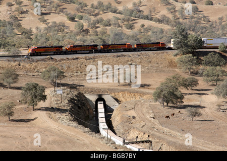 Eine ostwärts BNSF Güterzug klettert und übergibt sich am Tehachapi Loop zwischen Bakersfield und Mojave, Kalifornien. Stockfoto