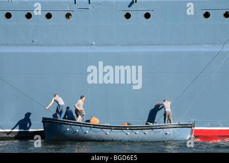 3 russische Matrosen Malerei der Corvette Steregushchy während einer Marine Parade in Sankt Petersburg, Russland Stockfoto