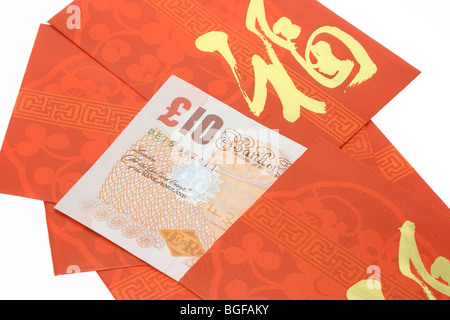 Chinesische neue Jahr rote Pakete und Bristsh Banknoten Stockfoto