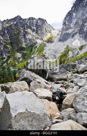 Eine Frau wandern in einem Feld in der Nähe von Boulder Colchuck See unterhalb Aasgard Pass in den Kaskaden Berge von Washington State, USA. Stockfoto