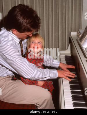 Klavierspielen für Tochter Vater Stockfoto