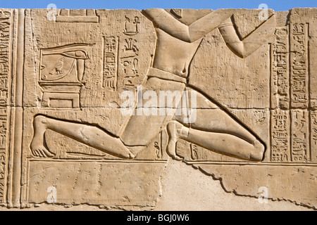 Entlastung der Mann kniet auf dem äußeren Gang am Tempel von Haroeris und Sobek in Kom Ombo im Niltal, Oberägypten Stockfoto