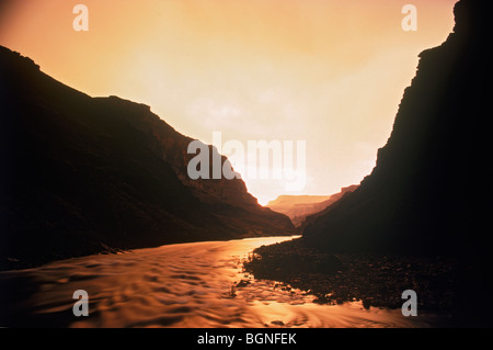 Colorado River running through the Grand Canyon reflecting sunset light like hot flowing lava Stockfoto