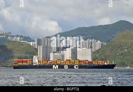 MSC Containerschiff, Toronto, Richtung Osten im Osten Lamma Channel, vorbei an einer Kulisse von Aberdeen Wolkenkratzer, Hong Kong, China Stockfoto