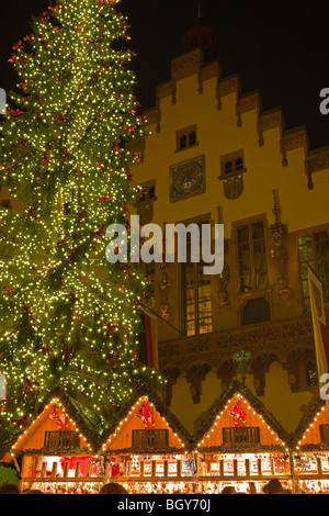 Christkindlmarkt (Weihnachtsmarkt) und einen hell erleuchteten Weihnachtsbaum aufgestellt vor der Römer, Rathaus (City Hall) in die Stockfoto