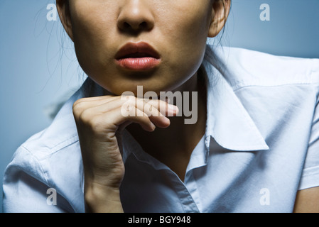 Frau mit der Hand unter Kinn, Nahaufnahme Stockfoto