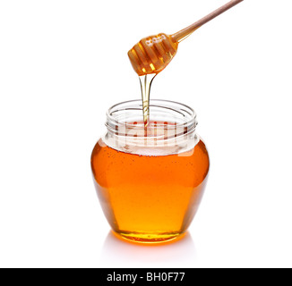 Honig-Schüssel und einem Drizzler isoliert auf weiss Stockfoto