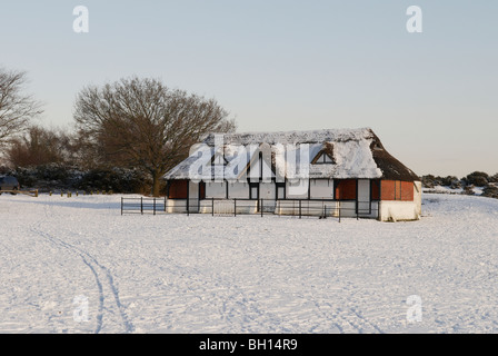 Die schneebedeckte Cricket Pavillion am Boltons Bank am Lyndhurst im New Forest National Park in Hampshire, England. Stockfoto