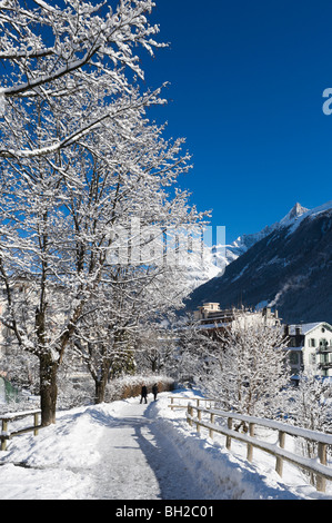 Wanderer unter Schnee bedeckt Bäume auf einem Pfad in der Nähe der Innenstadt, Chamonix Mont Blanc, Haute Savoie, Frankreich Stockfoto