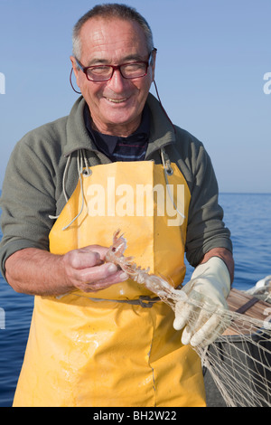 Fischer am Boot, Schleppnetzfischerei, Lächeln Stockfoto