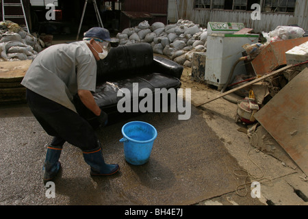 Einwohner von Sanjo Stadt Aufräumen nach einer Woche von sintflutartigen Regenfällen erzwungene Pausen in den Bänken des Flusses Igarashi, Japan. Stockfoto