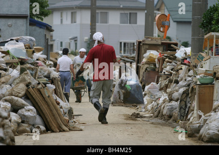 Einwohner von Sanjo Stadt Aufräumen nach einer Woche von sintflutartigen Regenfällen erzwungene Pausen in den Bänken des Flusses Igarashi, Japan. Stockfoto