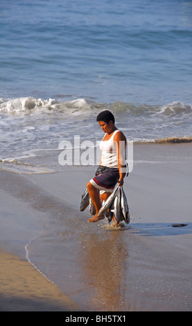 Puerto Escondido Oaxaca Mexico, Frau am Strand mit Fisch Stockfoto