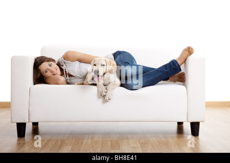 Junge schöne Frau zu Hause mit ihrem niedlichen Hund Stockfoto