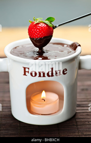 Erdbeere, eingetaucht in köstlichen geschmolzene Schokolade-fondue Stockfoto