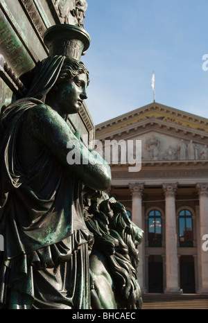 Bronze Statue von einer Frauen-Blicke über Münchner Opernhaus als Kulisse. Deutschland. Stockfoto