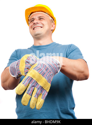 Arbeiterin mit gelben Helm Lederhandschuhe anziehen Stockfoto