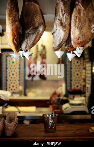 "Jamon Iberico" - iberischer Schinken von Eichel Schweine gefüttert hängend in einem Café in Sevilla, Spanien. Stockfoto