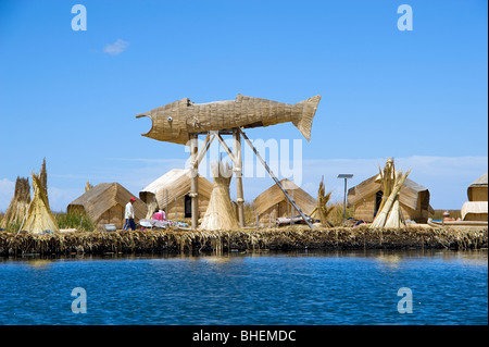 Eines der Uros Inseln am Titicacasee, Peru, zeigt Totora-Schilf-Nutzung und ein Fisch skulpturierten Aussichtsturm. Stockfoto