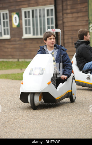 junge Leute fahren Sinclair C5 Elektro Dreirad auf sein 25-jähriges bestehen Stockfoto