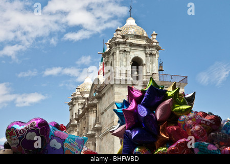 Glockentürme der Kathedrale von Oaxaca Stadt sind eingerahmt von zwei Berge von Helium-Ballons zum Verkauf auf dem Zocalo unten Stockfoto