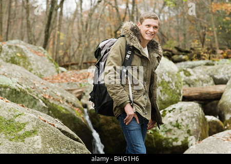 Junger Mann unter Steinen Stockfoto