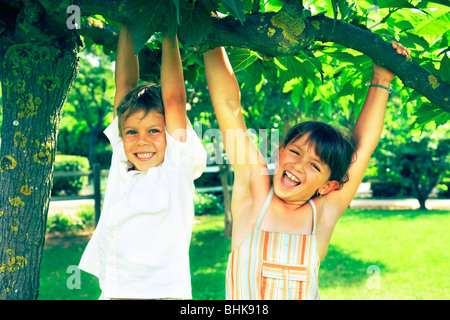 JUNGEN UND MÄDCHEN SPIELEN IN EINEM PARK Stockfoto