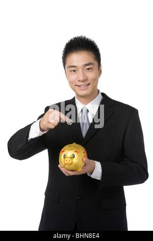 Geschäftsmann mit Sparschwein Stockfoto