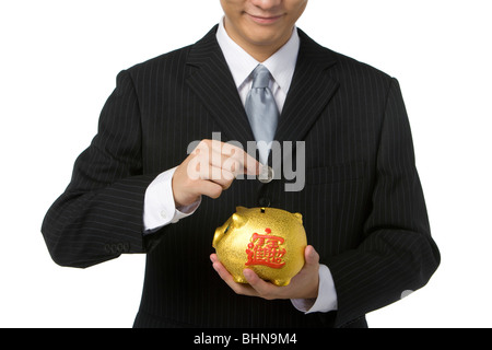Geschäftsmann mit Sparschwein Stockfoto