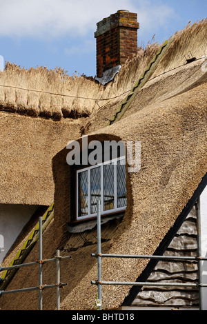 Strohdach - zeigt Fensterdetail mit Gerüst. Stockfoto