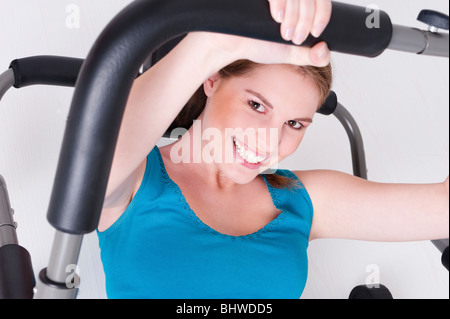 Junge schöne Frau unternimmt einige Sportarten in der Turnhalle Stockfoto