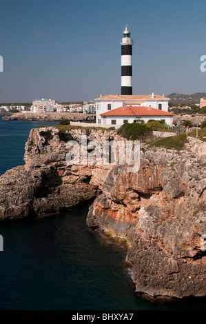 Schwarz und weiß lackiert Leuchtturm an felsiger Küste in der prallen Sonne Stockfoto