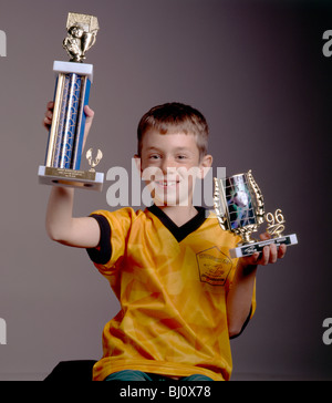 Porträt des jungen stolz hält seine Fußball-Trophäen empor Stockfoto