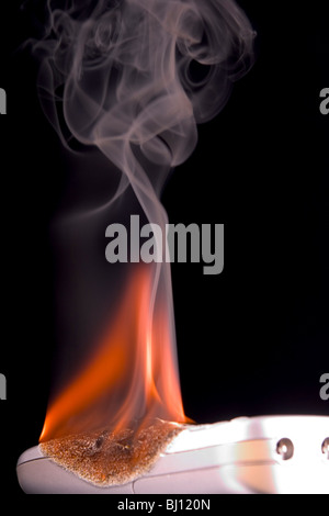 Verbrennungsgefahr Handy Stockfoto