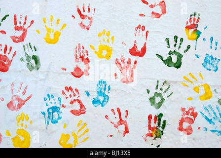 Bunte Handabdrücke auf weißen Wand Stockfoto