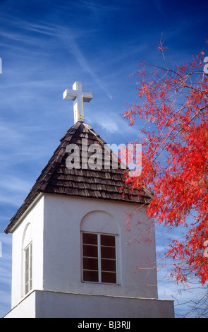 Ein Kirchturm mit einem Kreuz und rot fallen Niederlassungen in Minnesota, USA. Stockfoto