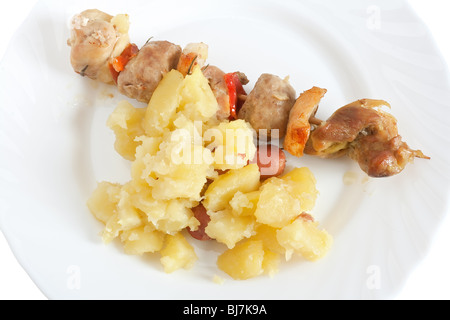 Detail der gebackenes Schweinefleisch Kebab mit Kartoffeln auf einem Teller Stockfoto