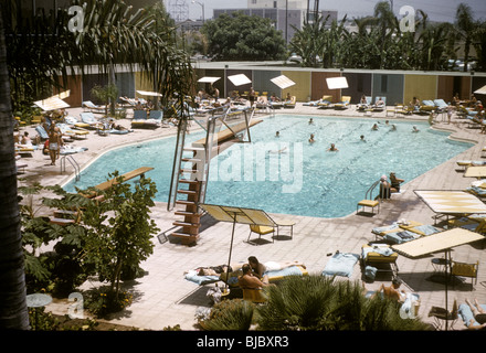 Schwimmer und Sonnenanbeter genießen Sie einen Sommertag im Beverly Hilton Hotel im Juli 1957. Reisen Sie Tourismus LA Architektur pool Stockfoto